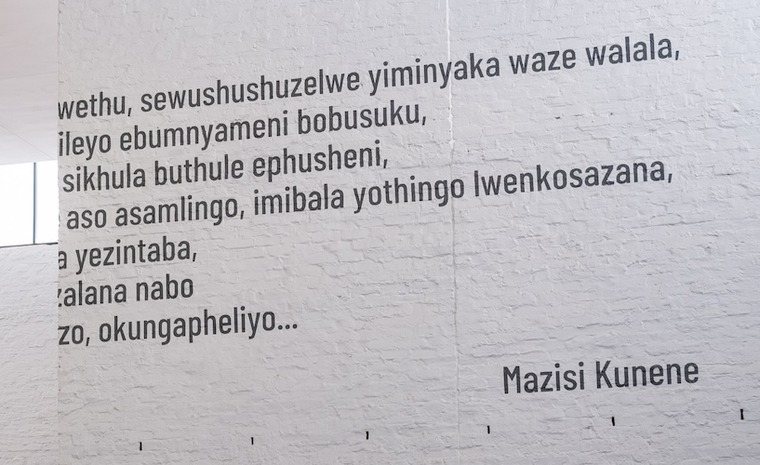 Lines of Mazisi Kunene's poetry in isiZulu on a wall